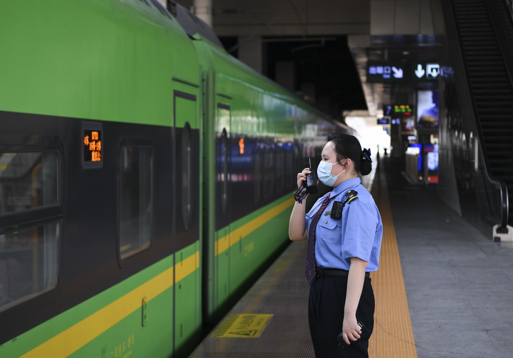 5月1日，重庆火车站站台客运人员与综控室工作人员沟通。 新华社 图