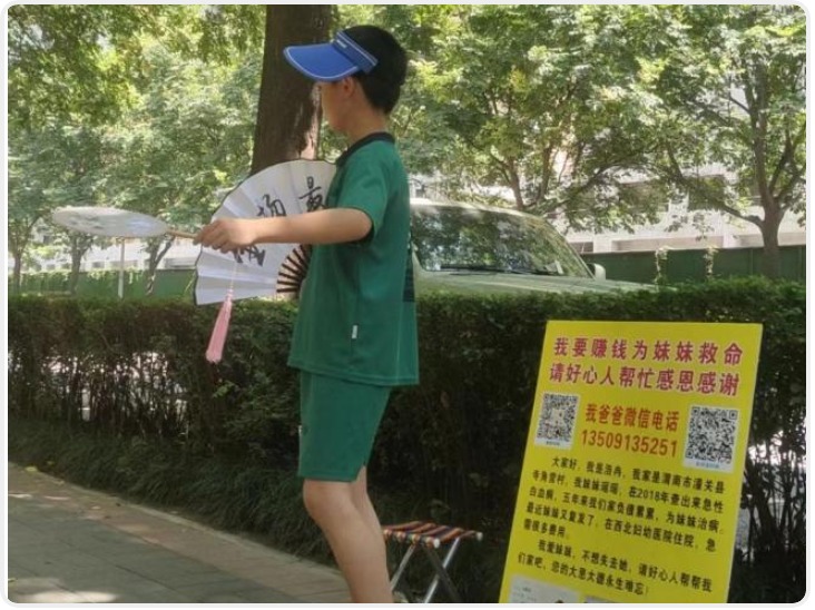 11岁男孩在西安街头摆摊卖扇子 想为白血病妹妹筹集手术费